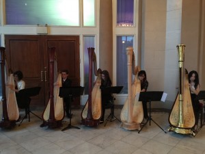 Harp Sinfonia members, Emma, Sebastian, Sage, Miranda and Vivian, warming up before performance