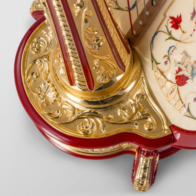 Ornate red and gold harp base